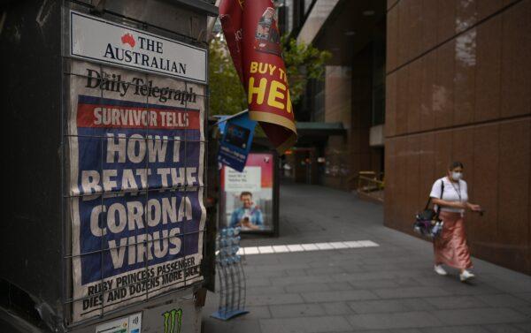A newspaper headline about the coronavirus outbreak is seen on a near-deserted street in Sydney on March 30, 2020. (PETER PARKS/AFP via Getty Images)
