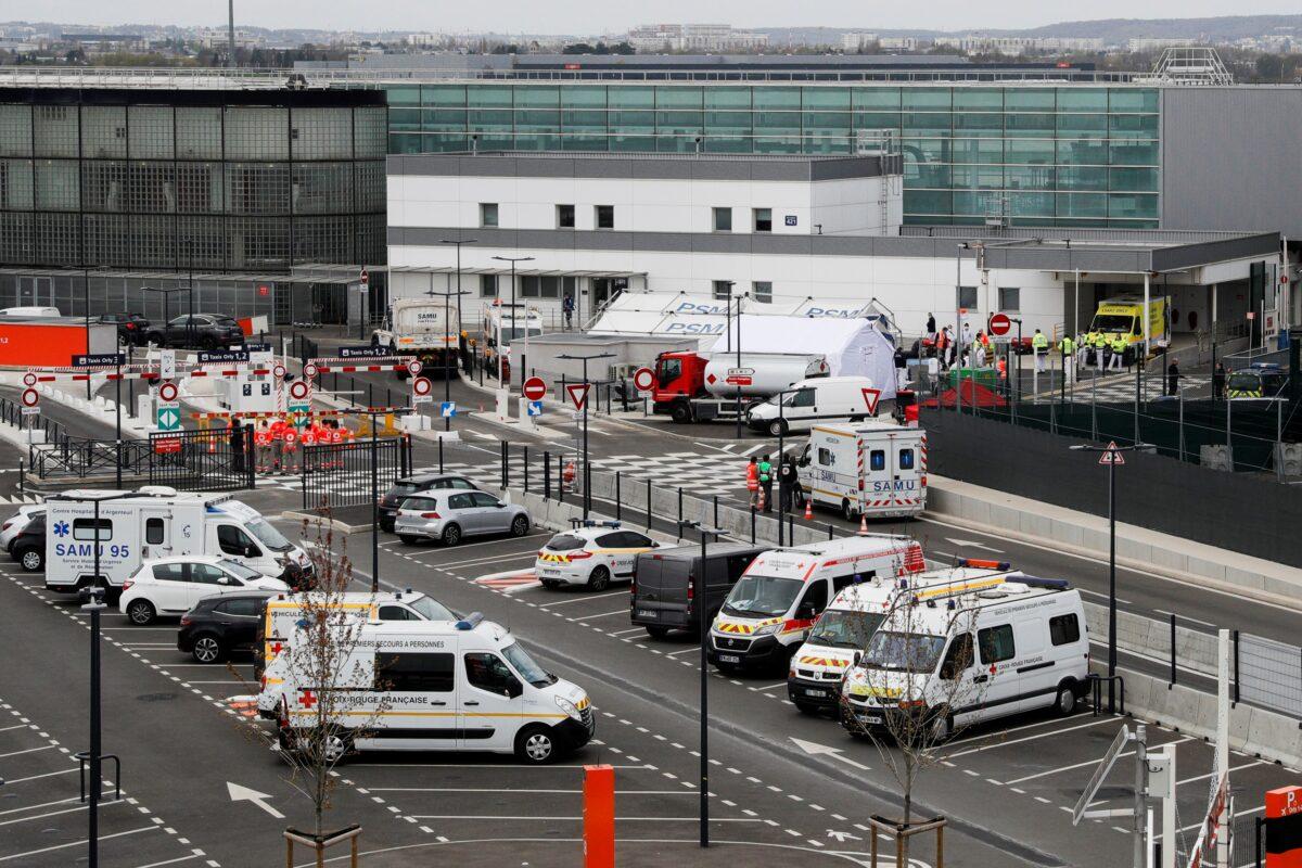 Ambulances transporting patients infected with Covid-19 prior to their evacuation by helicopter to a hospital outside Paris region, are parked at the Orly airport, south of Paris, France, on April 3, 2020. (Geoffroy Van Der Hasselt /AFP via Getty Images)