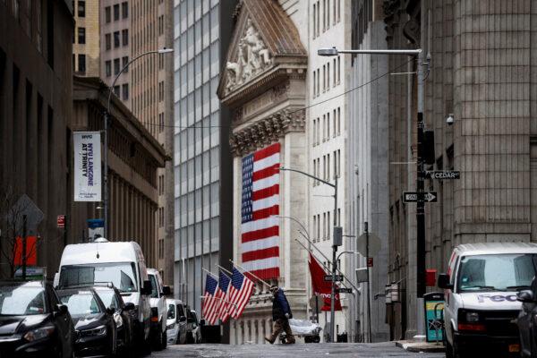 A man crosses a nearly deserted Nassau Street in front of the New York Stock Exchange (NYSE) in the financial district of lower Manhattan during the outbreak of the coronavirus disease (COVID-19) in New York City, New York, on April 3, 2020. (Mike Segar/Reuters)