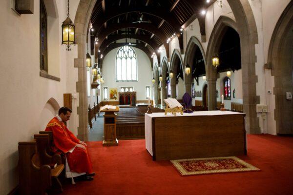 Father Peter Turrone pauses as he leads a Palm Sunday mass to an empty church at the St. Thomas Aquinas Catholic Church in Toronto, Canada, on April 5, 2020. (Cole Burston/Getty Images)