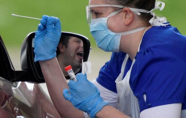 Medical staff test people at a CCP virus test centre in Chessington, UK, on April 2, 2020. (Toby Melville/Reuters)