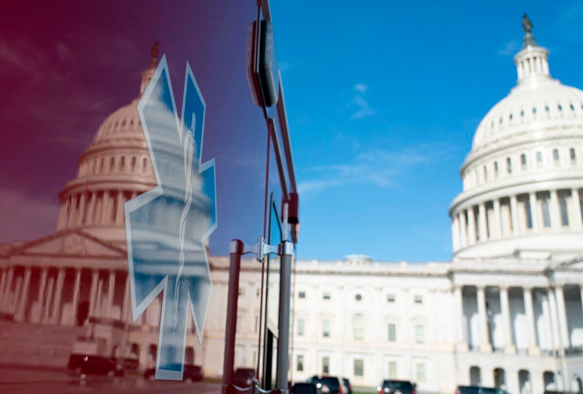 The U.S. Capitol is reflected in a standby ambulance in Washington on March 27, 2020. (Alex Edelman/AFP via Getty Images)