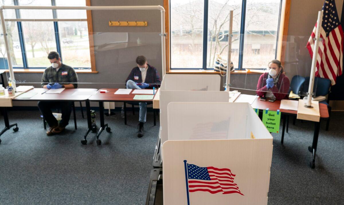Poll workers wait for voters at a polling location in Madison, Wisconsin on April 7, 2020. (Andy Manis/Getty Images)