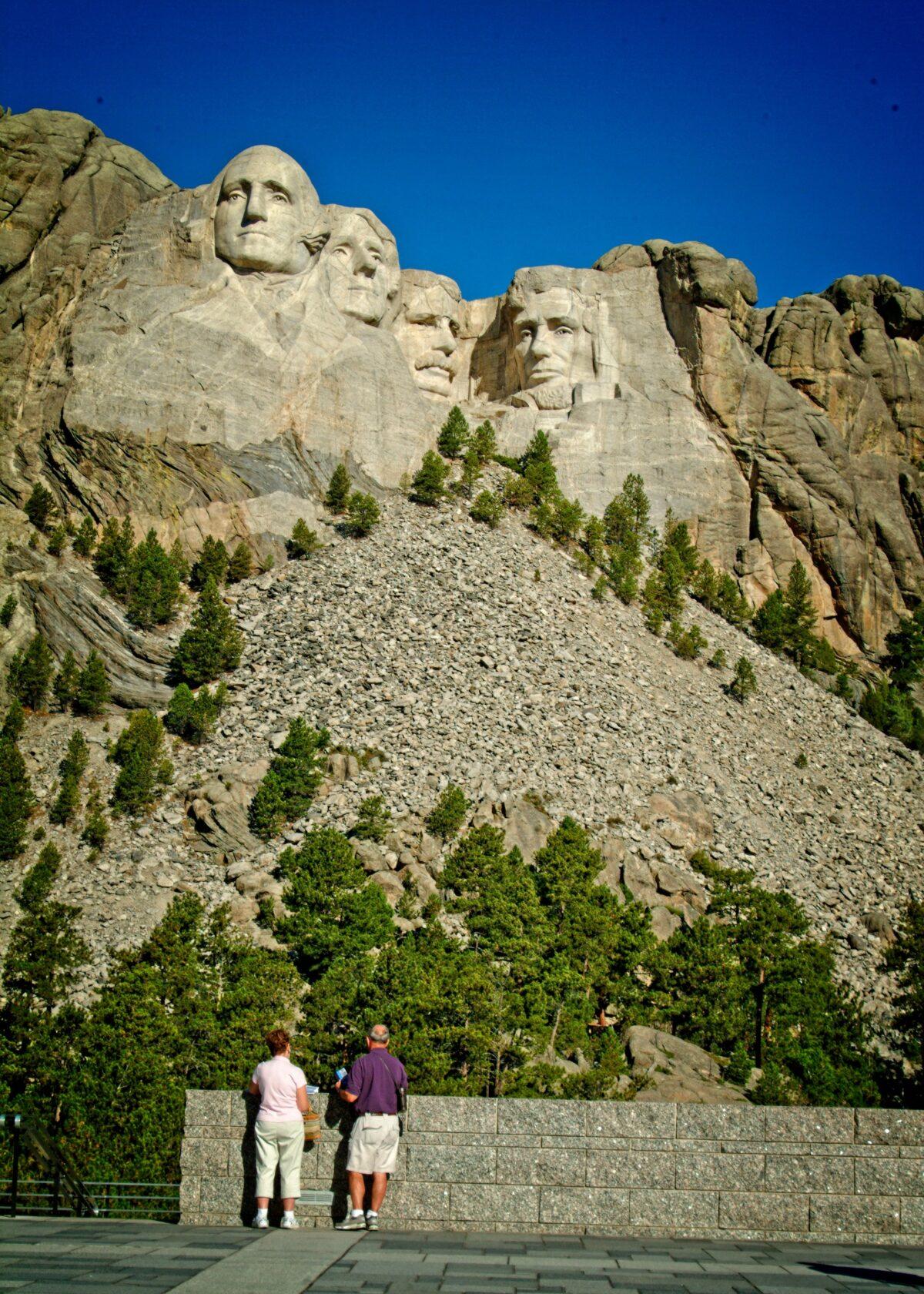 The sheer size of Mount Rushmore National Memorial overwhelms visitors when they stand at the viewing platform and look up at the images of the four great American leaders. (Copyright Fred J. Eckert)