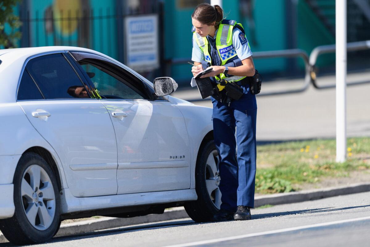 A police stops a car traveling toward Christchurch at a checkpoint in Amberley, New Zealand, on April 10, 2020. (Kai Schwoerer/Getty Images)