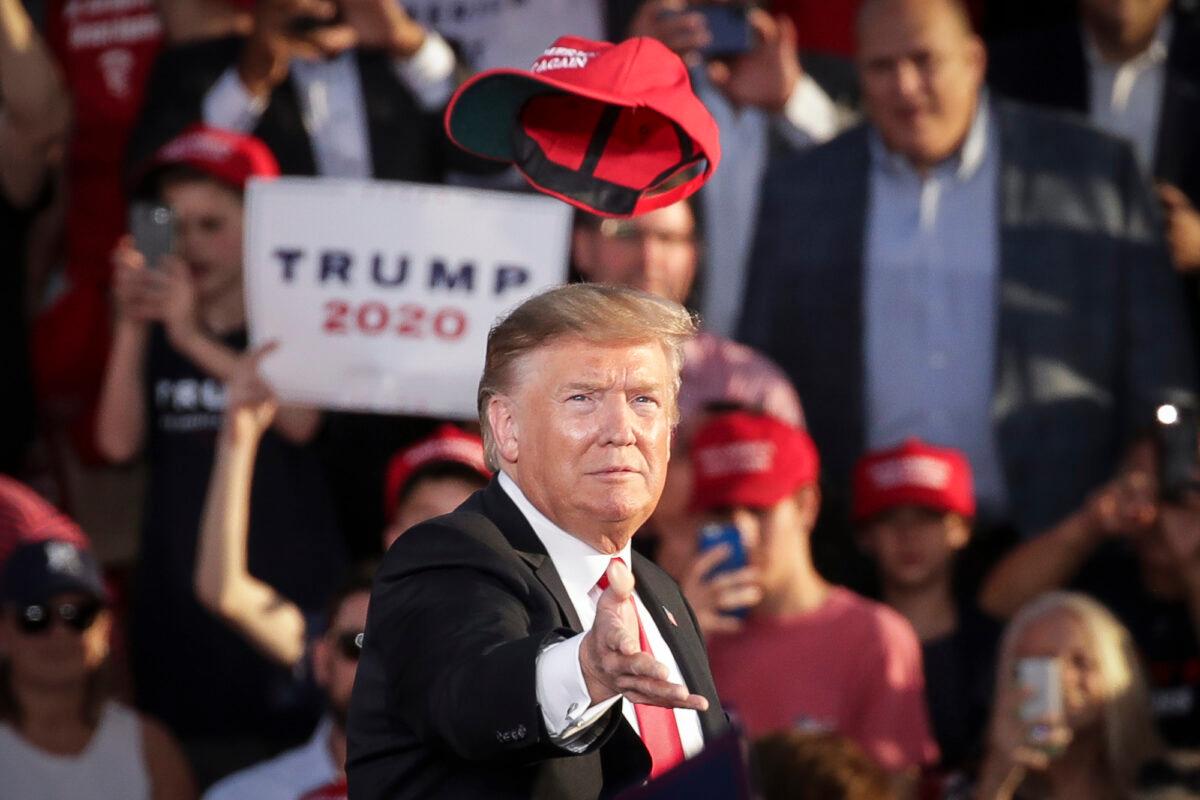 President Donald Trump tosses a hat into the crowd as he arrives for a campaign rally in Montoursville, Pa., on May 20, 2019. (Drew Angerer/Getty Images)