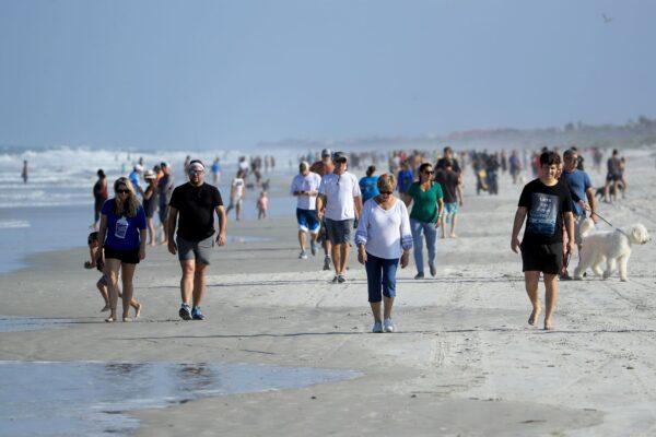 People are seen at the beach in Jacksonville Beach, Florida on April 17, 2020. Jacksonville Mayor Lenny Curry announced Thursday that Duval County's beaches would open at 5 p.m. but only for restricted hours and can only be used for swimming, running, surfing, walking, biking, fishing, and taking care of pets. (Sam Greenwood/Getty Images)