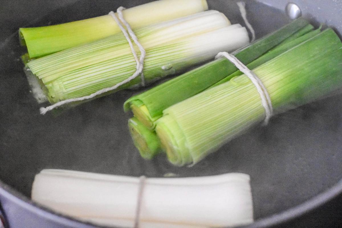 Poaching the leeks renders them soft and sweet. (Audrey Le Goff)