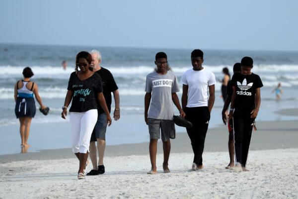 People walk down Jacksonville Beach in Florida on April 19, 2020. (Sam Greenwood/Getty Images)
