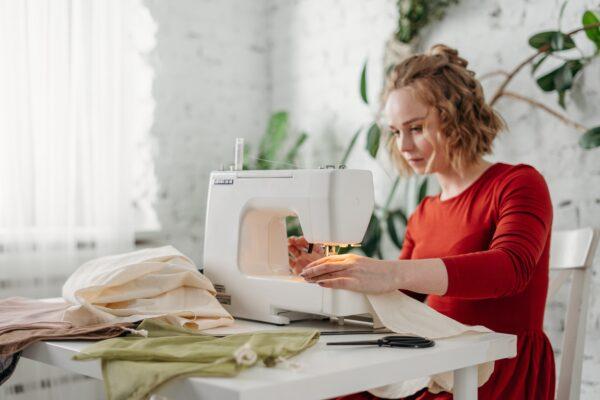 A file photo of a woman using a sewing machine. (Cottonbro/Pexels)