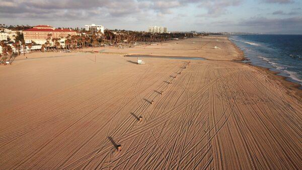 An aerial view shows a stretch of empty Santa Monica beach as parks and beaches are off limits to help stem the spread of the novel CCP virus, which causes COVID-19, on April 16, 2020. (Robyn Beck/AFP via Getty Images)