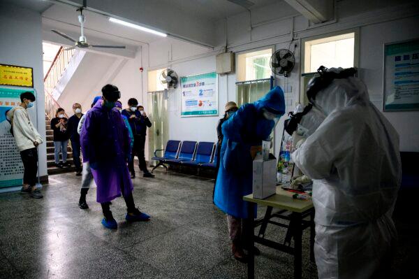 People are waiting to be tested for the CCP virus at the Wuhan No. 8 Hospital in Wuhan, China on April 10, 2020. (Noel Celis/AFP via Getty Images)