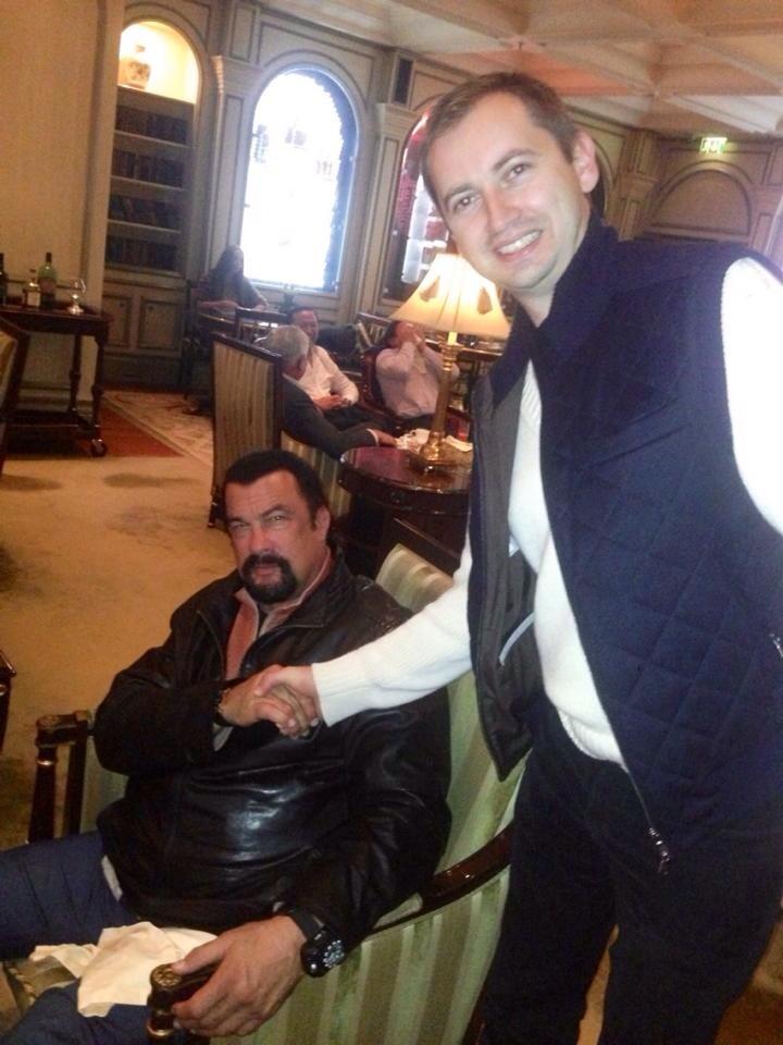 Sergei Millian (R) shakes hands with actor Steven Seagal in the lobby of the Ritz-Carlton hotel in Moscow in October 2013. (Sergei Millian)