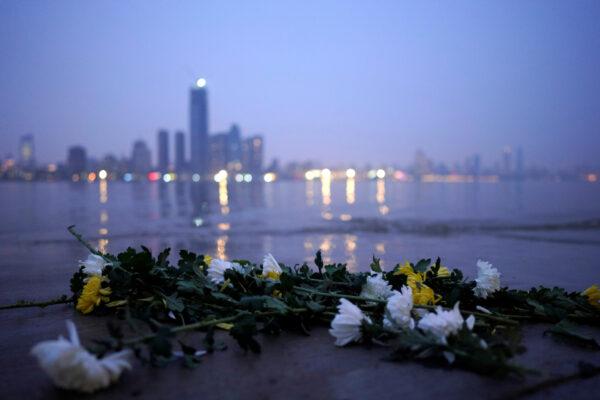 Fresh chrysanthemum flowers, a traditional Chinese funeral flower, lie on the banks of the Yangtze River on the eve of the Tomb-sweeping Festival in Wuhan, Hubei province, the epicenter of China's COVID-19 outbreak, in Wuhan, China, on April 3, 2020. (Aly Song/Reuters)