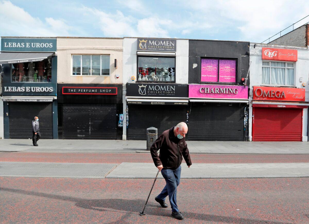 Pedestrians walk alongside closed shops during the CCP virus lockdown in London, UK, on May 5, 2020. (Frank Augstein/AP Photo)
