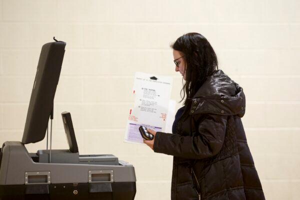 A woman holds a ballot at a polling place at Cromie Elementary School in Warren, Mich., on March 10, 2020. (Elaine Cromie/Getty Images)