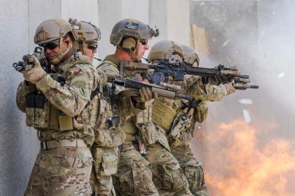 U.S. Special Forces Green Beret Soldiers, assigned to 7th Special Forces Group (Airborne), Operational Detachment-A, prepare to breach an entry point during a close quarter combat scenario while Integrated Training Exercise 2-16 at Marine Corps Air Ground Combat Center, Twentynine Palms, Calif., on Feb. 10, 2016. (U.S. Air Force photo by Tech Sgt. Efren Lopez/Released)