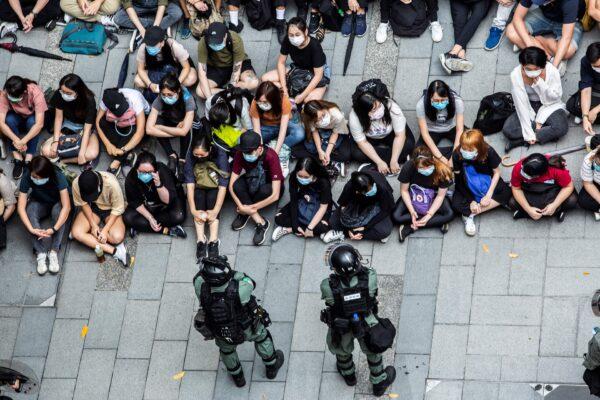 Riot police detain a group of people during a protest in the Causeway Bay district of Hong Kong on May 27, 2020, as the city's legislature debates over a law that bans insulting China's national anthem. (Isaac Lawrence/AFP via Getty Images)
