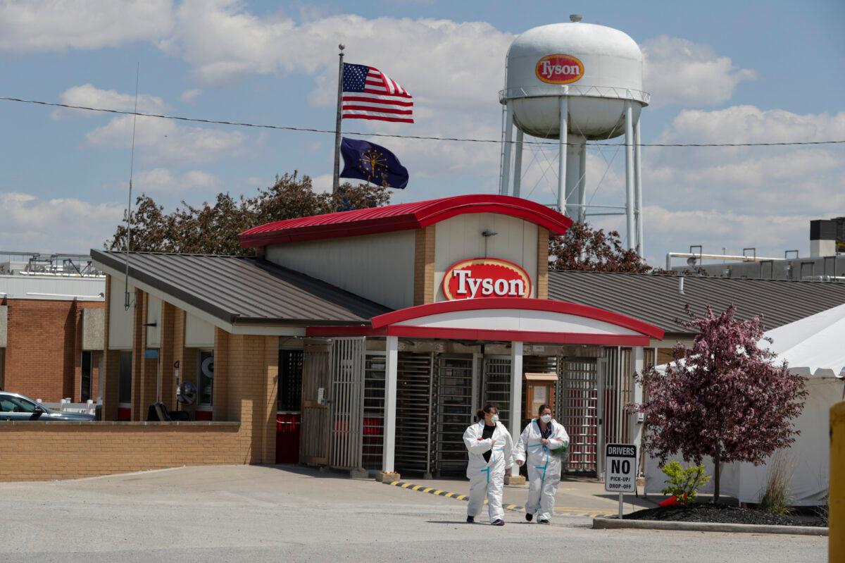 Workers leave the Tyson Foods pork processing plant in Logansport, Ind., on May 7, 2020. (AP Photo/Michael Conroy)