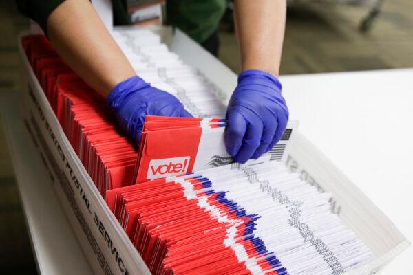 Election workers sort vote-by-mail ballots for the presidential primary at King County Elections in Renton, Wash., on March 10, 2020. (Jason Redmond/AFP via Getty Images)