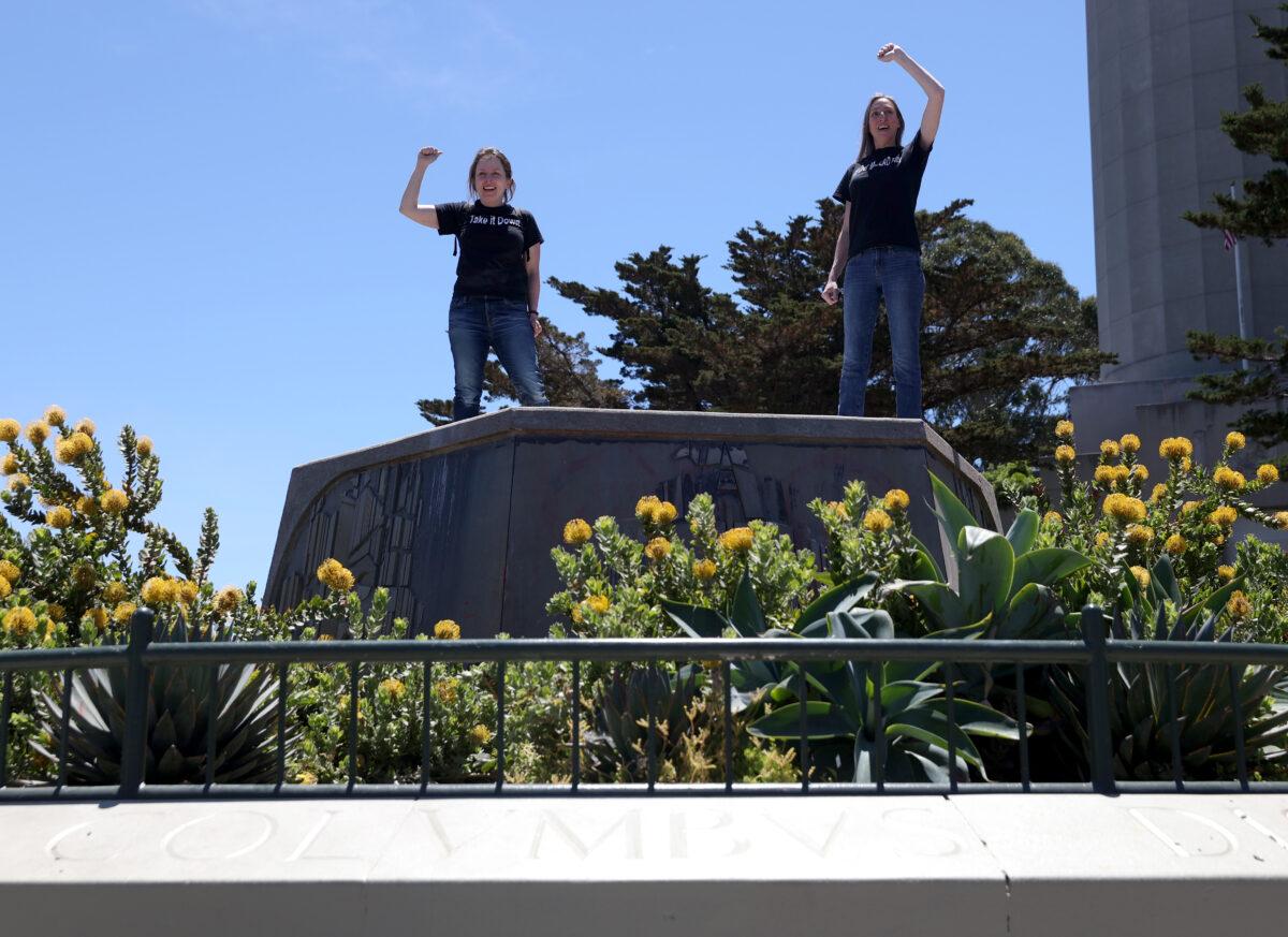 People stand on a concrete pedestal where a statue of Christopher Columbus once stood at the foot of Coit Tower in San Francisco, Calif., on June 18, 2020. (Justin Sullivan/Getty Images)