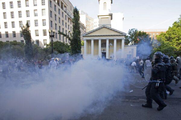 Police officers shooting tear gas push back demonstrators next to St. John's Episcopal Church outside of the White House, on June 1, 2020. (Jose Luis Magana/AFP via Getty Images)