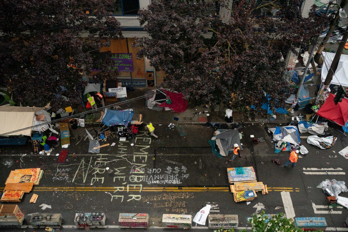 City crews dismantle the Capitol Hill Organized Protest (CHOP) area outside of the Seattle Police Department's vacated East Precinct in Seattle on July 1, 2020. (David Ryder/Getty Images)