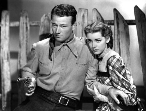 John Wayne and Marsha Hunt in the 1937 film "Born to the West." (Public Domain)
