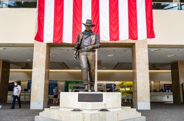 A 9-foot-tall statue of John Wayne stands at John Wayne Airport in Orange County, Calif., on June 26, 2020. (John Fredricks/The Epoch Times)