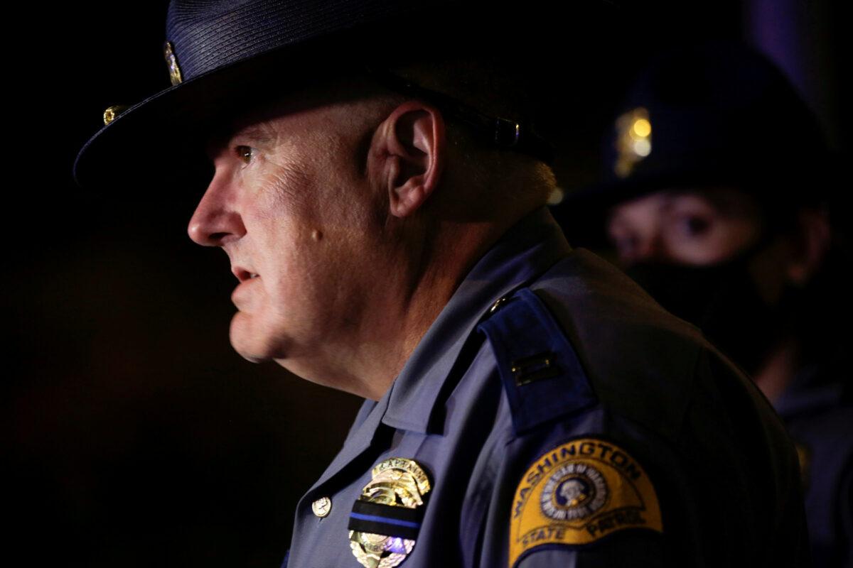 Washington State Patrol Capt. Ron Mead briefs media near the scene where two protesters were struck by a car on I-5 in Seattle. (Jason Redmond/Reuters)
