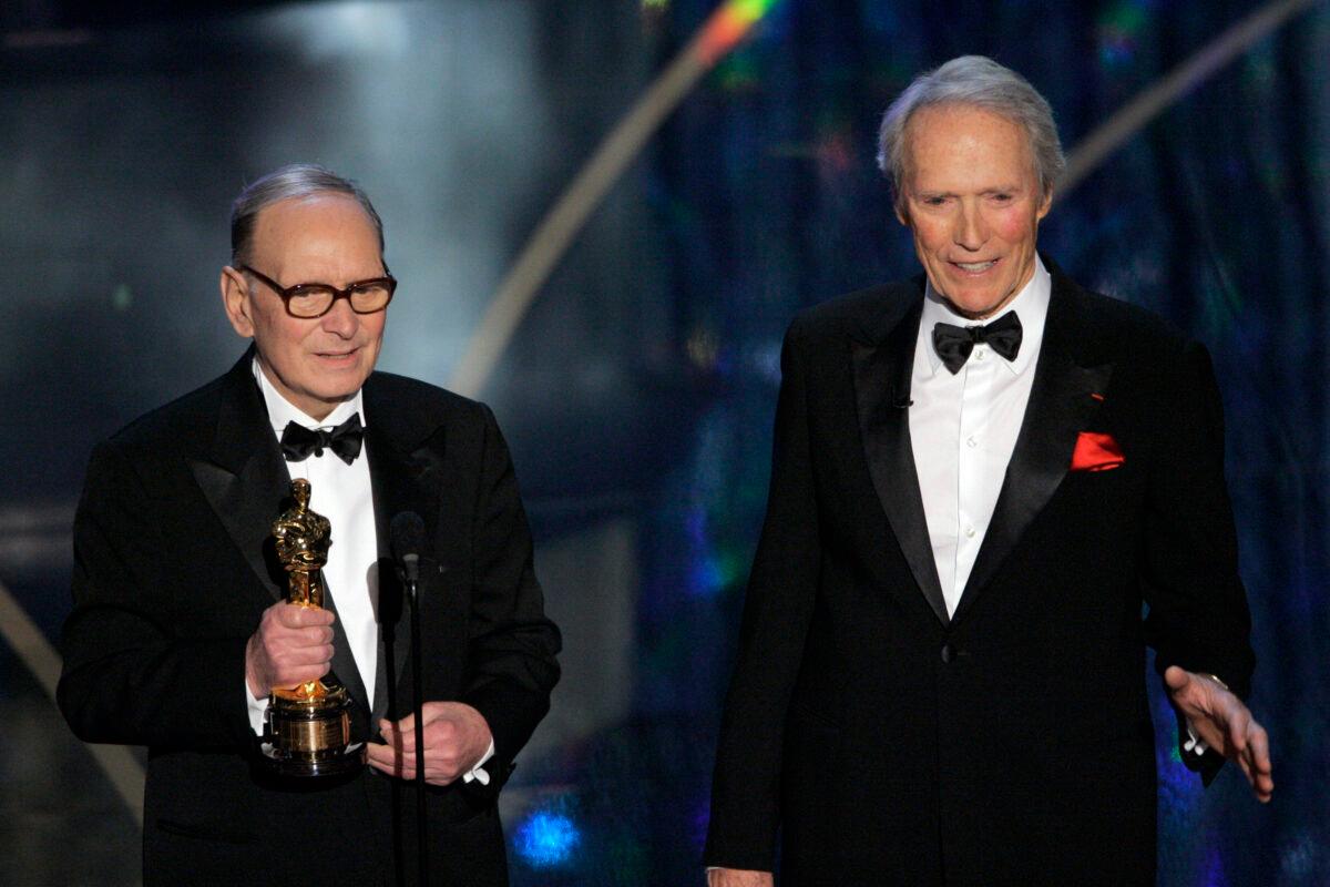 Italian composer Ennio Morricone (L) accepts an honorary Oscar for his contributions to the art of film music as director Clint Eastwood looks on during the 79th Academy Awards telecast in Los Angeles, Calif., on Feb. 25, 2007. (Mark J. Terrill/file/AP Photo)