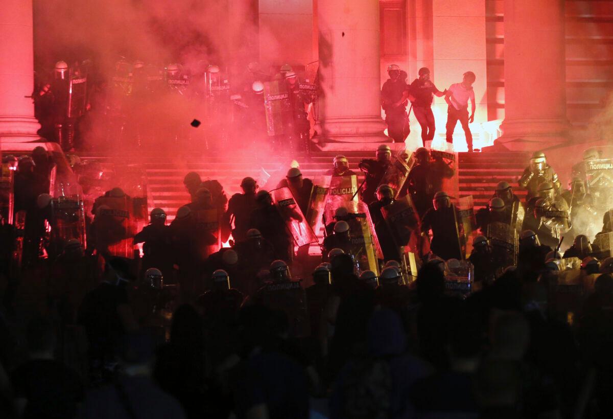 Protesters clash with riot police on the steps of the Serbian parliament during a protest in Belgrade, Serbia, on July 10 2020. (Darko Vojinovic/AP Photo)