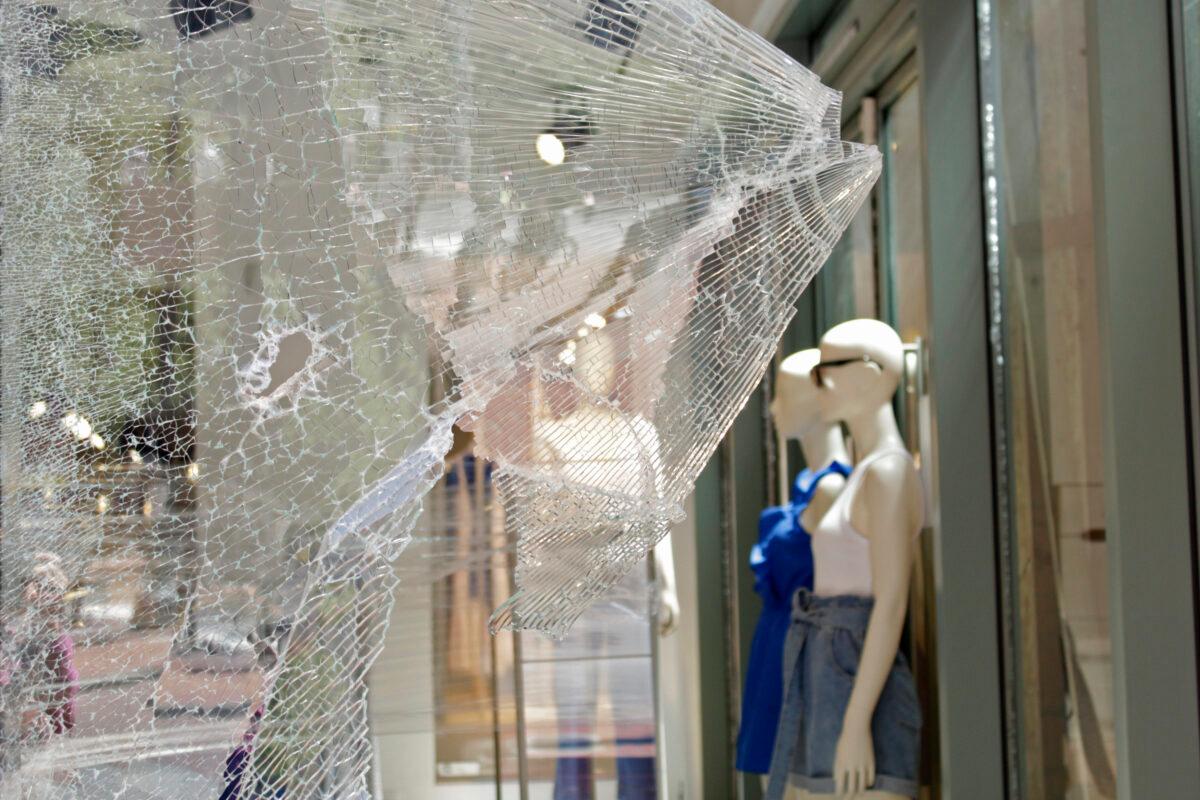Mannequins are seen through shattered glass at an H&M store in downtown Portland, Ore., after violent demonstrations the night before, on July 13, 2020. (Gillian Flaccus/AP Photo)