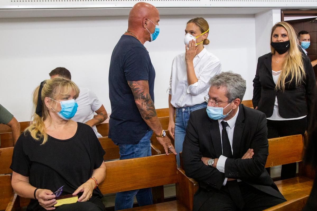 Israeli top model Bar Refaeli, center, wears a mask as she arrives to a court along with her mother, Zipi, left, her father, Raffi, center, and lawyers, in Tel Aviv, Israel, on July 20, 2020. (Oded Balilty/AP)