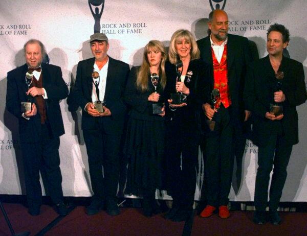 Members of Fleetwood Mac hold their awards after the group was inducted into the Rock and Roll Hall of Fame, in New York on Jan. 12, 1998. (Adam Nadel/AP Photo)