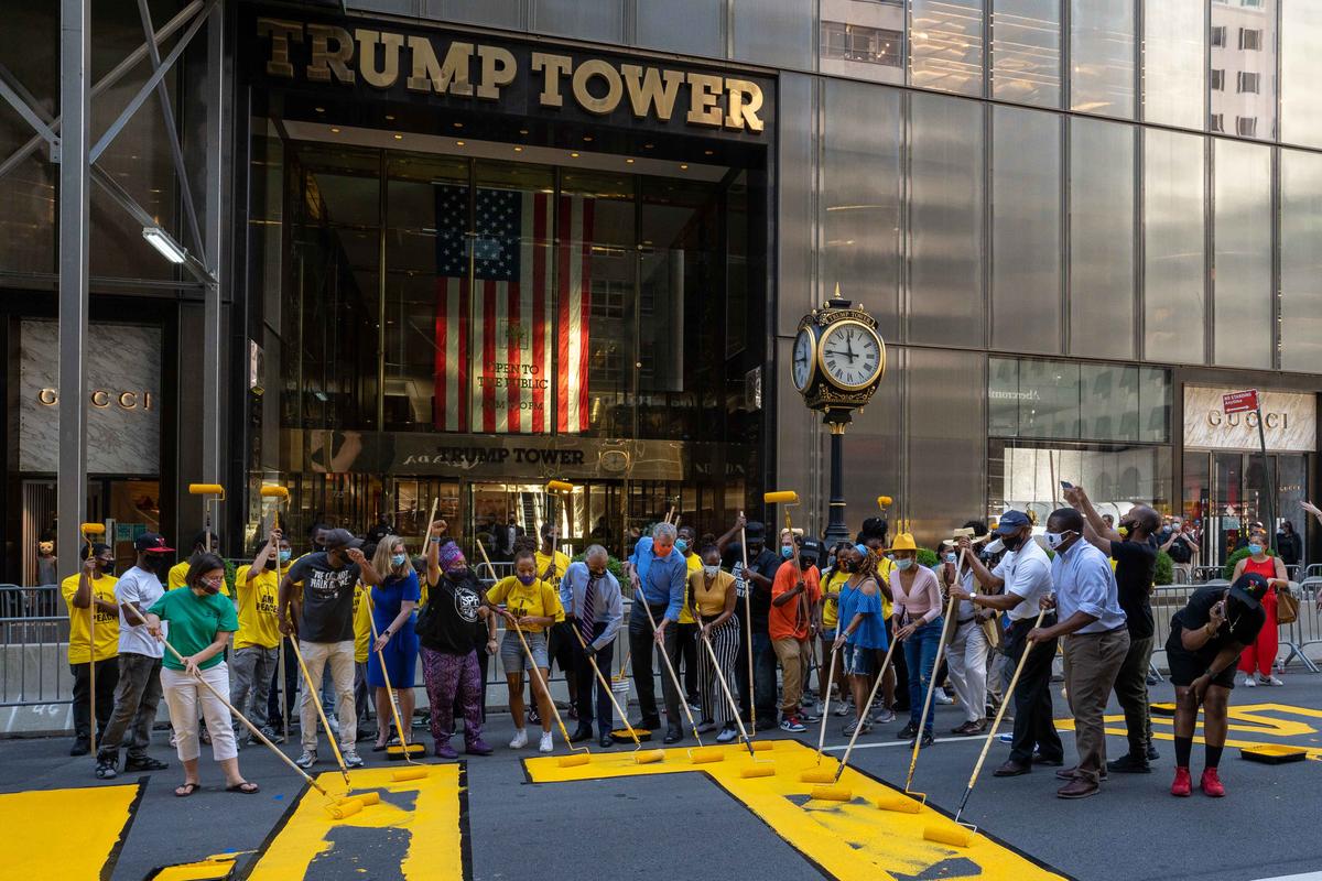 New York City Mayor Bill de Blasio, his wife Chirlane McCray and Rev. Al Sharpton help paint a Black Lives Matter mural on Fifth Avenue directly in front of Trump Tower on July 9, 2020 in New York City. (David Dee Delgado/Getty Images)