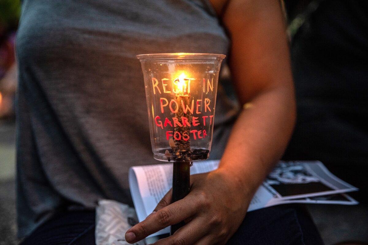 An attendee holds a candle at a vigil for Garrett Foster in downtown Austin, Texas, on July 26, 2020. (Sergio Flores/Getty Images)