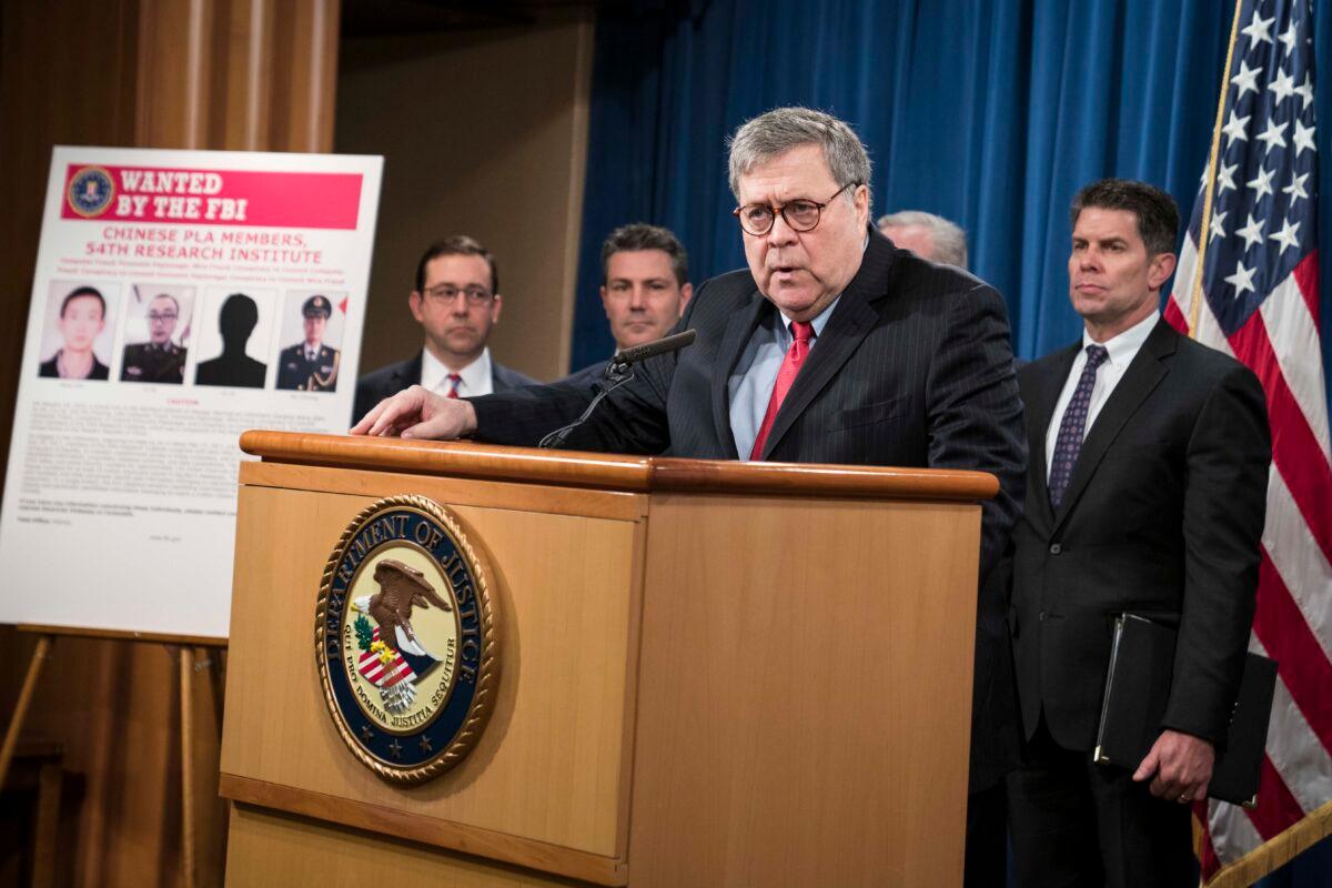 Attorney General William Barr participates in a press conference at the Department of Justice in Washington on Feb. 10, 2020. Barr announced the indictment of four members of China's military on charges of hacking into Equifax Inc. and stealing data from millions of Americans. (Sarah Silbiger/Getty Images)