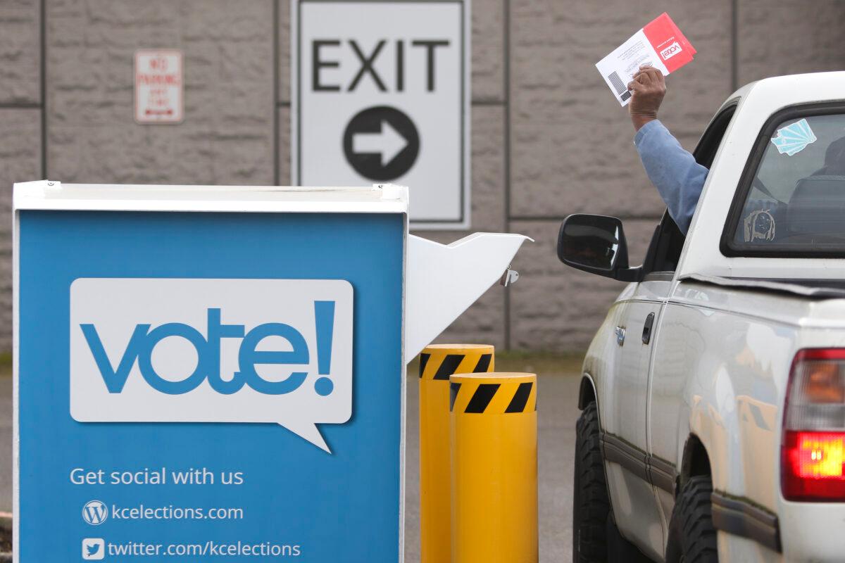 Voters drop off their presidential primary mail-in ballots at a drop box at King County Elections in Renton, Wash., on March 10, 2020. (Jason Redmond/AFP via Getty Images)