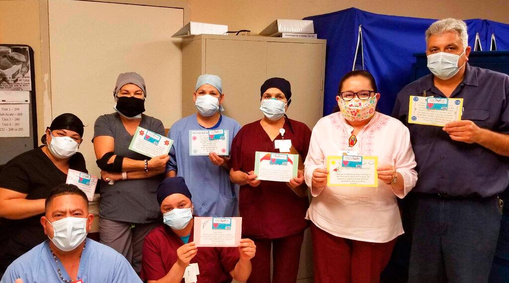 Health care workers hold thank-you cards at Los Angeles Community Hospital in Los Angeles on June 30, 2020. (Keith Levy via AP)