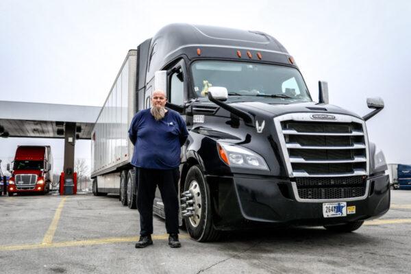 Truck driver Randy Griffith stands next to his Freighliner at the TA Truck Service truck stop in London, Ohio, on March 19, 2020. (Charlotte Cuthbertson/The Epoch Times)