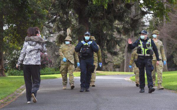 Police officers and soldiers patrol Treasury Gardens as they enforced strict lockdown laws in Melbourne, Australia on Aug. 5, 2020. (William West/AFP via Getty Images)
