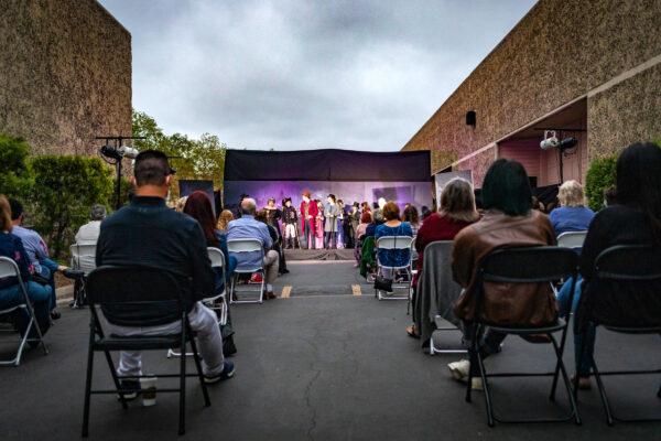 The Braver Players stand on an outdoor stage before an enthusiastic crowd for a performance of the musical "Jekyll & Hyde" during the COVID-19 pandemic in Costa Mesa, Calif., on Aug. 5, 2020. (John Fredricks/The Epoch Times)
