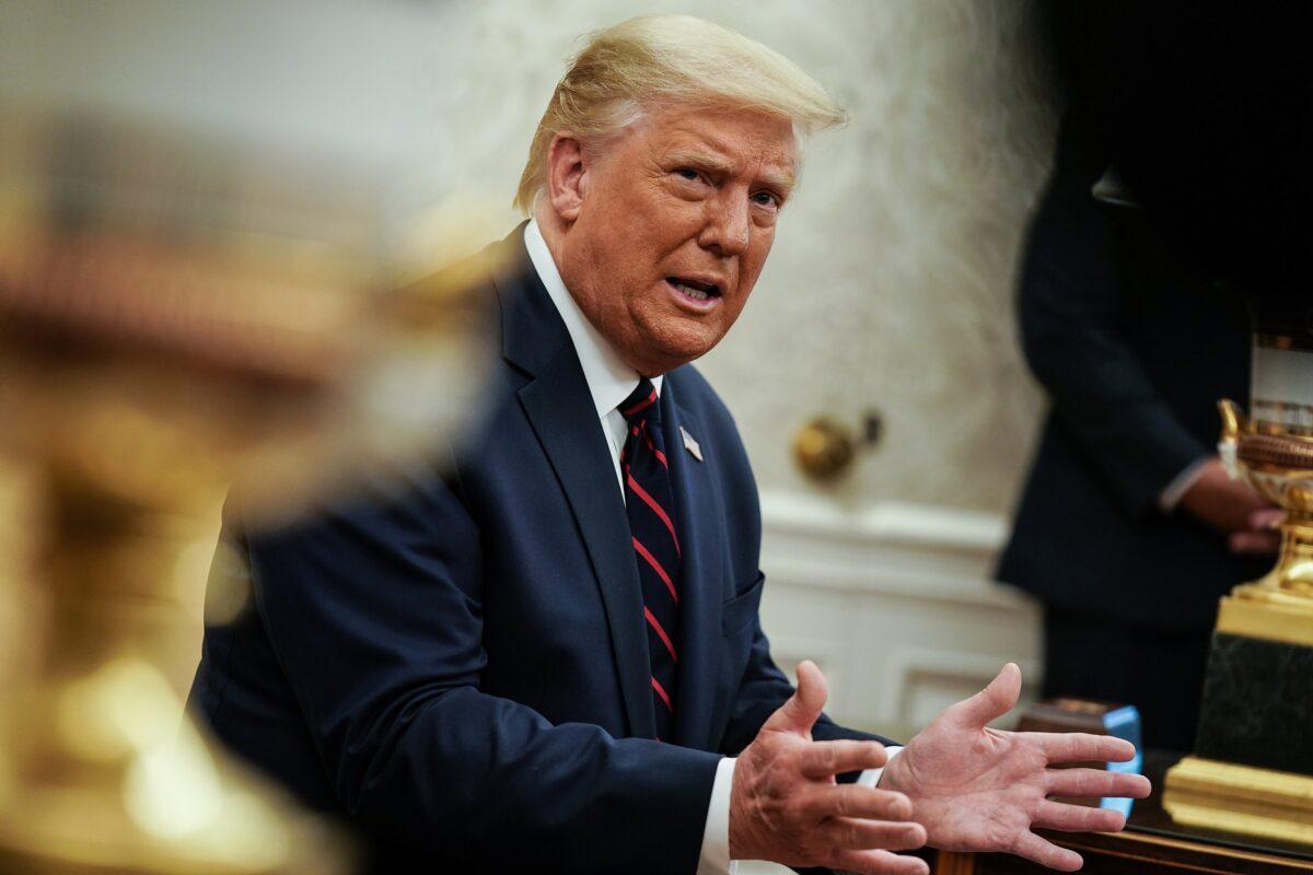 President Donald Trump talks to reporters in the Oval Office of the White House in Washington on Aug. 20, 2020. (Anna Moneymaker/Pool/Getty Images)