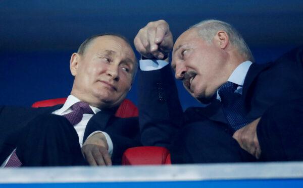 Russian President Vladimir Putin and Belarusian President Alexander Lukashenko speak in the stands during the closing ceremony of 2019 European Games, in Minsk, on June 30, 2019. (Vasily Fedosenko/Reuters)
