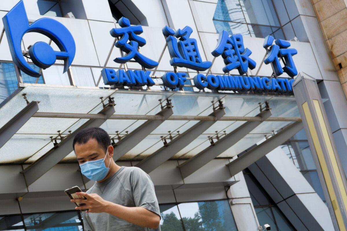 A man walks past an office of Bank of Communications in Beijing, China, on Aug. 27, 2020. (Thomas Peter/Reuters)