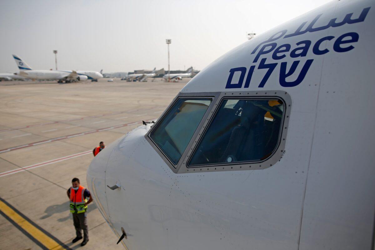 The Arabic, English, and Hebrew words for "peace" is seen on the Israeli flag carrier El Al's airliner which will carry Israeli and U.S. delegations to Abu Dhabi at Ben Gurion Airport, near Tel Aviv, Israel, on Aug. 31, 2020. (Nir Elias/Pool Photo via AP)