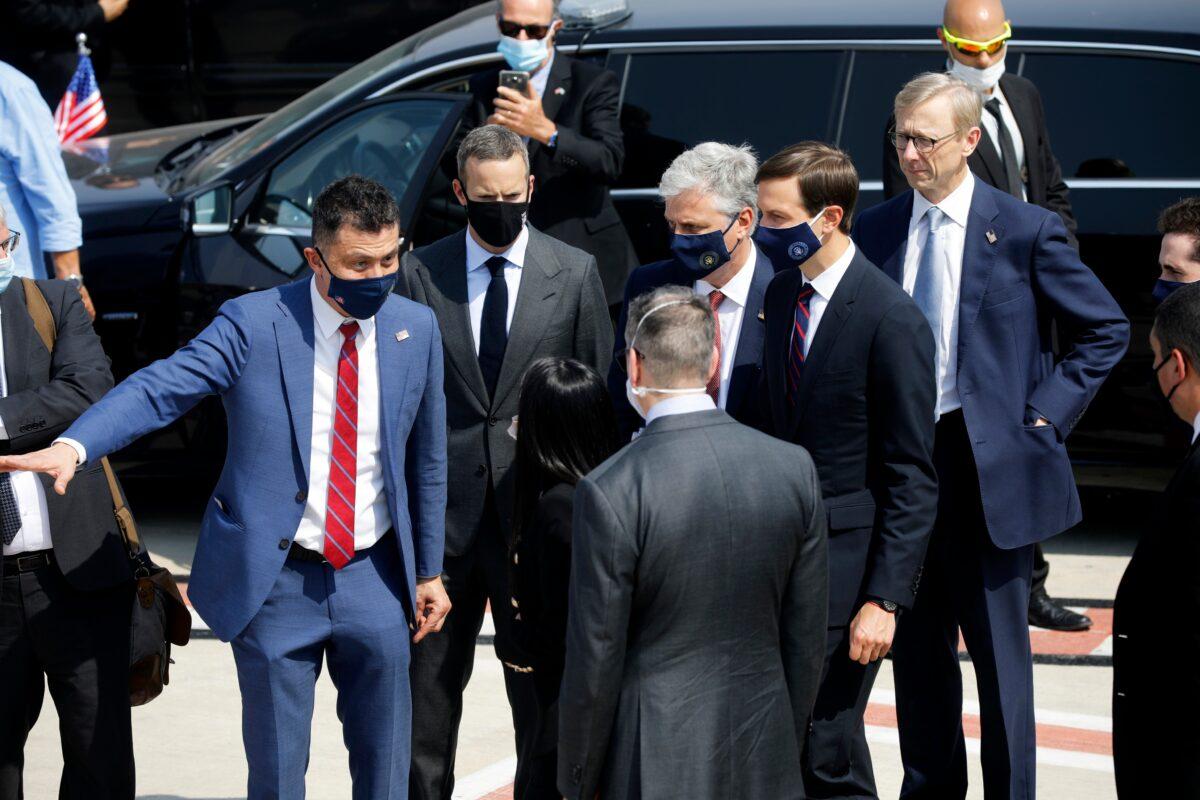 U.S. National Security Advisor Robert O'Brien, center right, and U.S. President Trump's senior adviser Jared Kushner, second from right, prepare to board a flight with an Israeli delegation to Abu Dhabi for talks meant to put final touches on the normalization deal between the United Arab Emirates and Israel, at Ben-Gurion International Airport, near Tel Aviv, Israel, on Aug. 31, 2020. (Nir Elias/Pool Photo via AP)