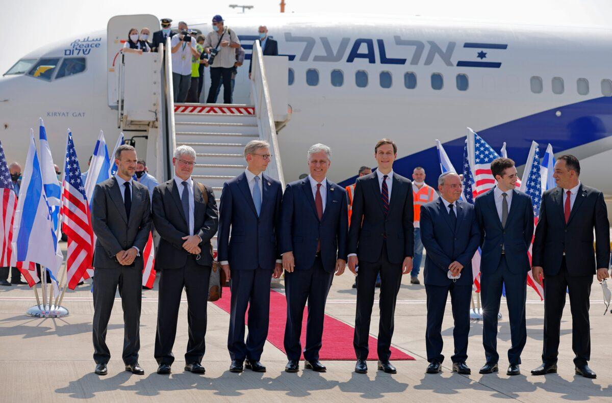 U.S. Presidential Adviser Jared Kushner, center right, and U.S. National Security Adviser Robert O'Brien, center left, pose with members of the Israeli-American delegation in front of the El Al's flight, which will carry the delegation from Tel Aviv to Abu Dhabi, at the Ben Gurion Airport near Tel Aviv, Israel, on Aug. 31, 2020. (Menahem Kahana/Pool Photo via AP)