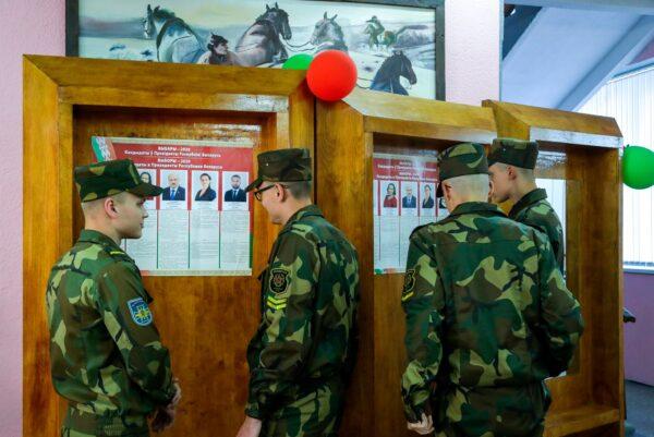 Belarusian soldiers read about the candidates before voting at a polling station during the presidential election in Minsk, Belarus, on Aug. 9, 2020. (Sergei Grits/AP Photo)